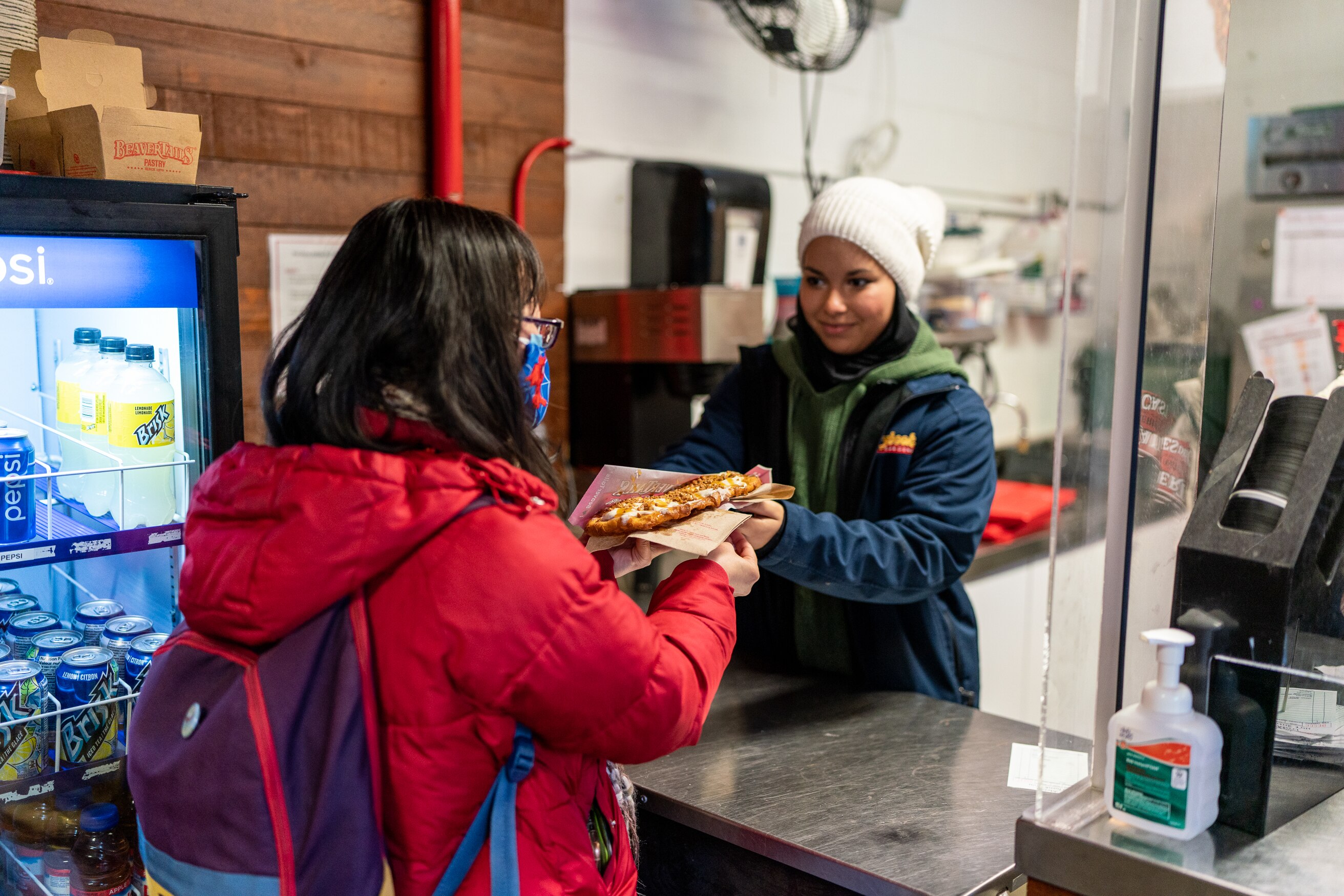 Storybook Gardens staff member giving food to person