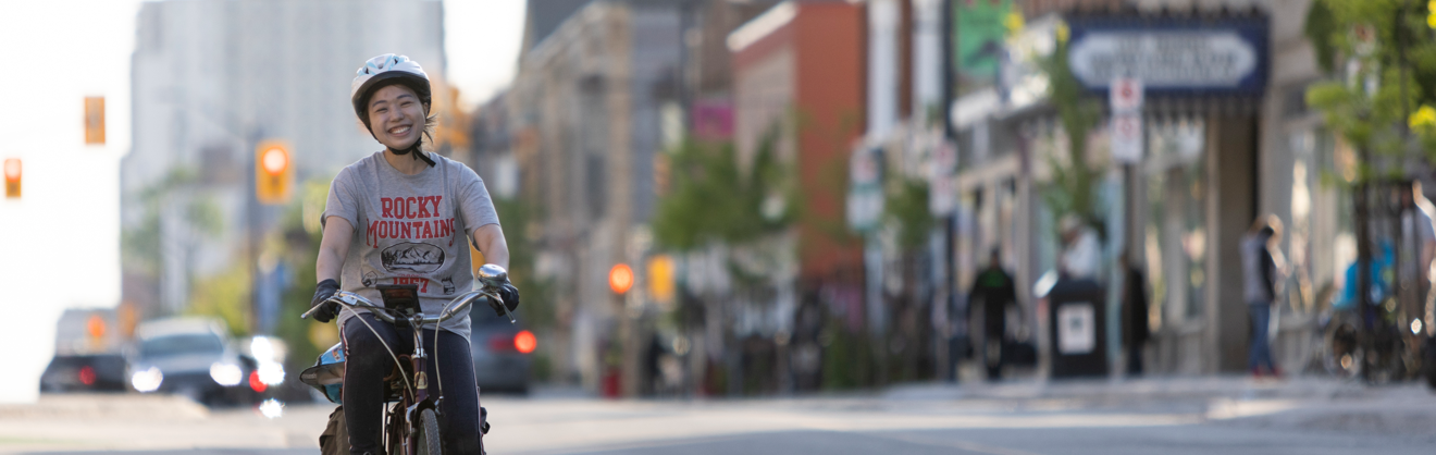 smiling cyclist using protected bike lane